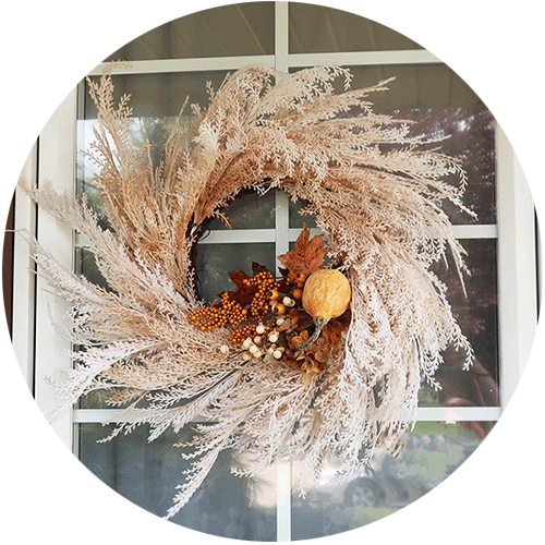 Fall wreath with a floral pick added to it.